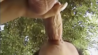 Dynamic brunette with big tits giving massive dick handjob outdoor