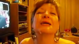 A mature wife takes a load of her hubby's sticky cum all over her face