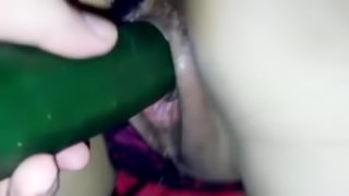 Wife fingering and masturbating with a cucumber with husband help