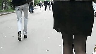 A hottie in black dominates this street upskirt video