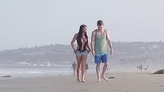 Young couple takes a walk on the beach and stops for a outdoor fuck