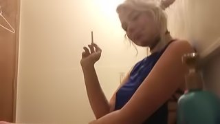 sexy skinny blonde smokes in front of boyfriend