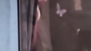 Neighbor is undressing on the window voyeur video