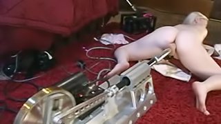 Cute blonde babe gets a sex machine and start using it in her house