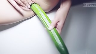 Sexy babe is playing with cucumber
