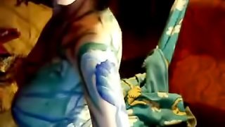 A bosomy girl lets her boyfriend paint her plump body