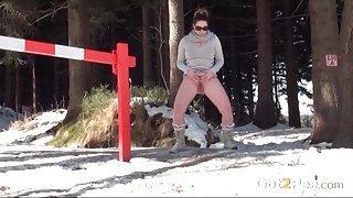 Busty sweater girl pees in the snow