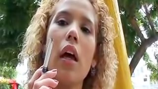 Sexy latina smokes in outdoor