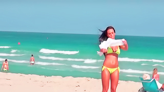 Sexy curves are seen on the beach in this scene
