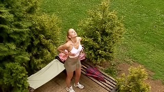 Blonde gets her out out and fucks herself in the garden